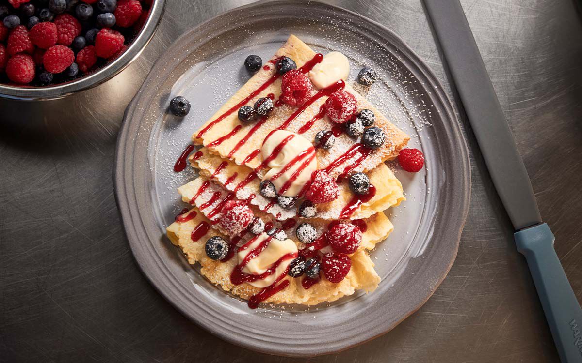 Plated crepes topped with fruit