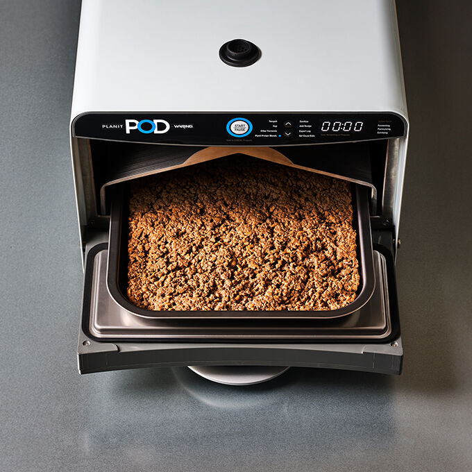 Planit POD with door open and tray of ground protein inside