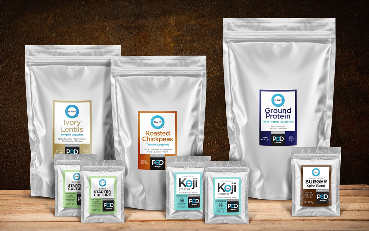 Planit Protein bags of cultures and blends on a wooden tabletop